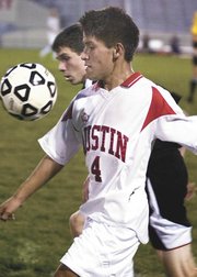 Austin's Francisco Torres settles the ball along the sidelines Thursday night in the first half against Rochester John Marshall at Art Hass Stadium.