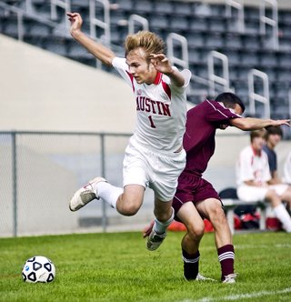 Austin's Jacob Larson is sent flying after colliding with Pine Island/Zumbrota-Mazeppa's Noah Smith in the first half Saturday afternoon at Art Hass Stadium.